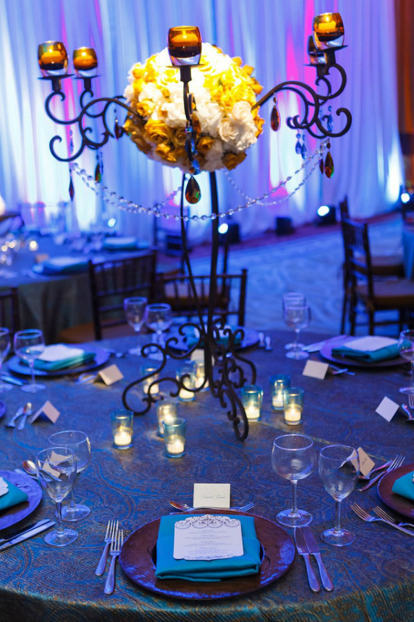 blue and yellow themed wedding centerpiece with crystals