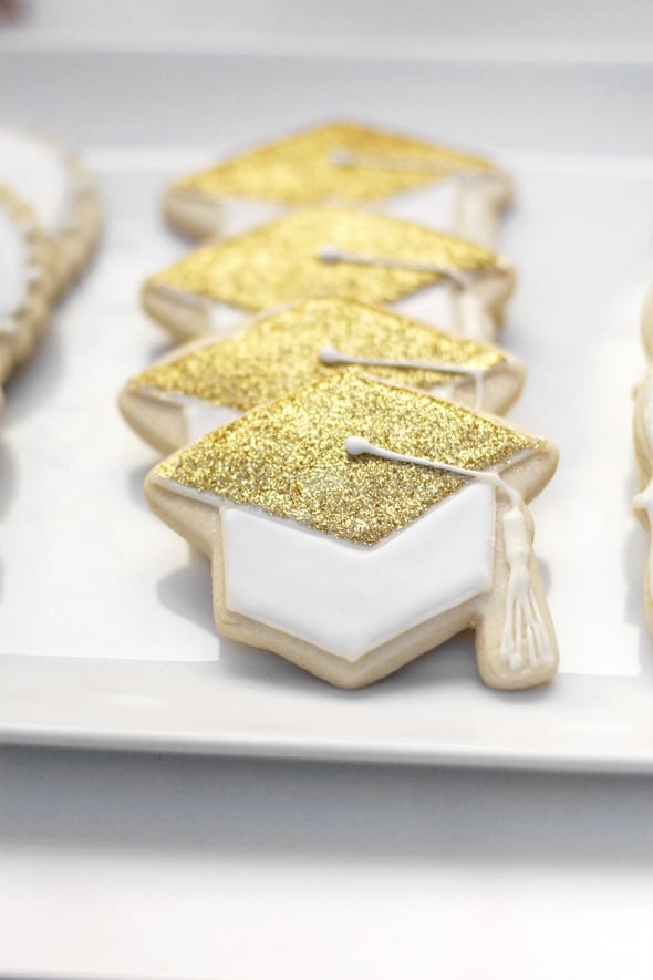 Gold and white glittery graduation cap cookies