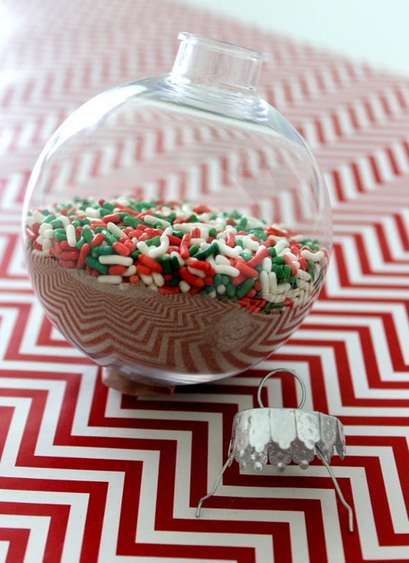 Plastic ball ornament with hot cocoa and holiday sprinkles
