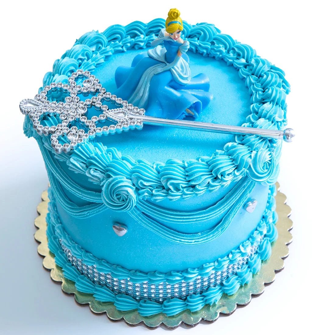 This bright blue Cinderella birthday cake is a fun, classic choice for a princess party. The bold blue frosting, piped buttercream swirls, rhinestone-style trim, Cinderella figurine, and sparkling magic wand topper make it feel playful, kid-friendly, and instantly recognizable.