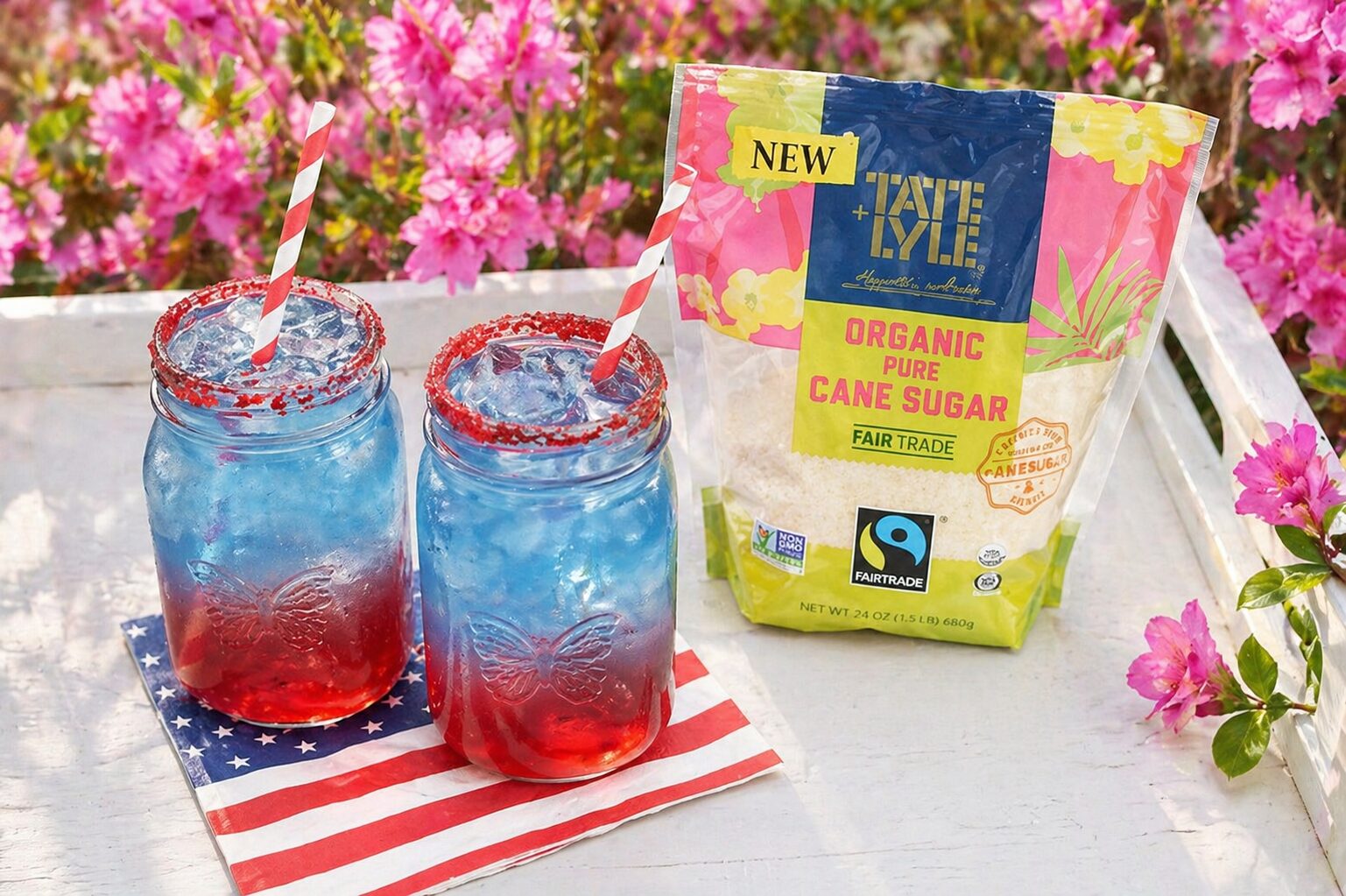 Patriotic punch with red sugar rims served in clear glasses for a festive Memorial Day or Fourth of July party.