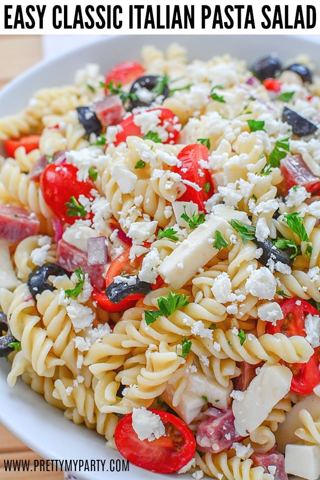 Grab the recipe for this Easy Classic Italian Pasta Salad from Pretty My Party. It's the perfect side dish for parties, summer barbecues and more. It feeds a large crowd and is delicious.