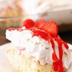 Easy strawberry shortcake lasagna slice with whipped cream, fresh strawberries, and strawberry glaze on a white plate.