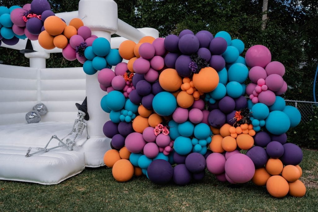 Orange, purple, pink and teal balloon wall