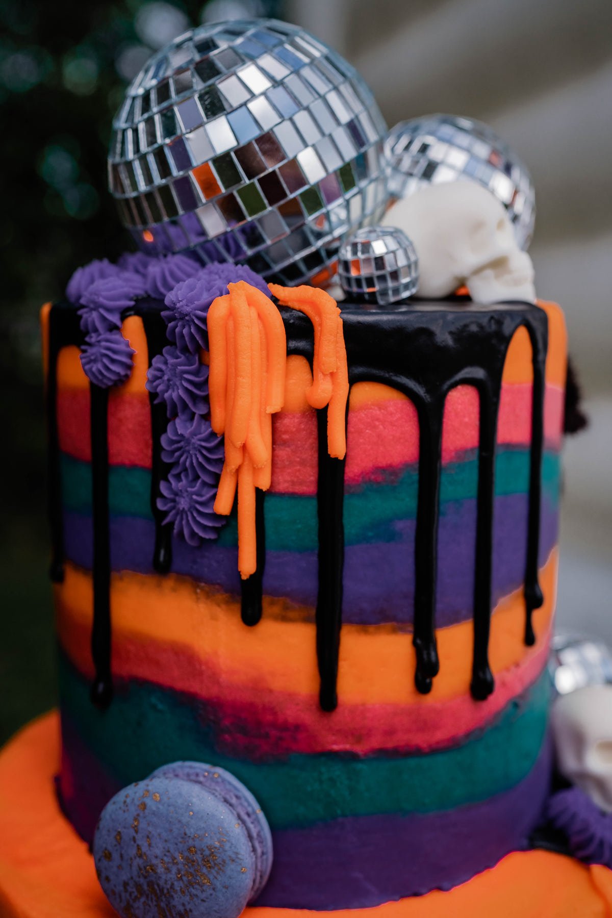 Drip cake with disco ball and skull cake topper