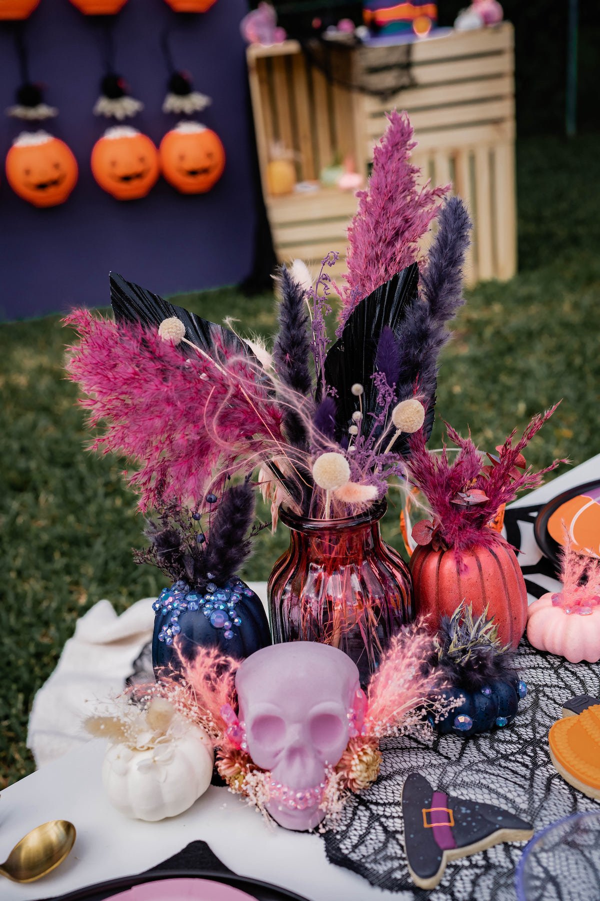 Colorful bedazzled pumpkins, skull heads and dried flower arrangements