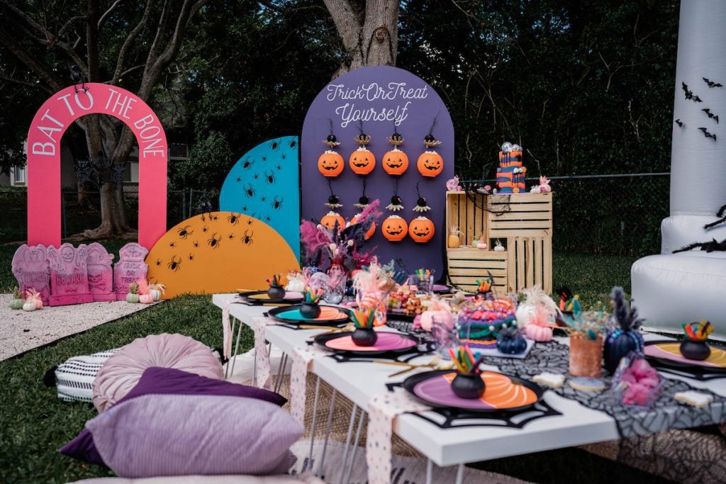 Colorful Halloween backyard party with picnic-style seating