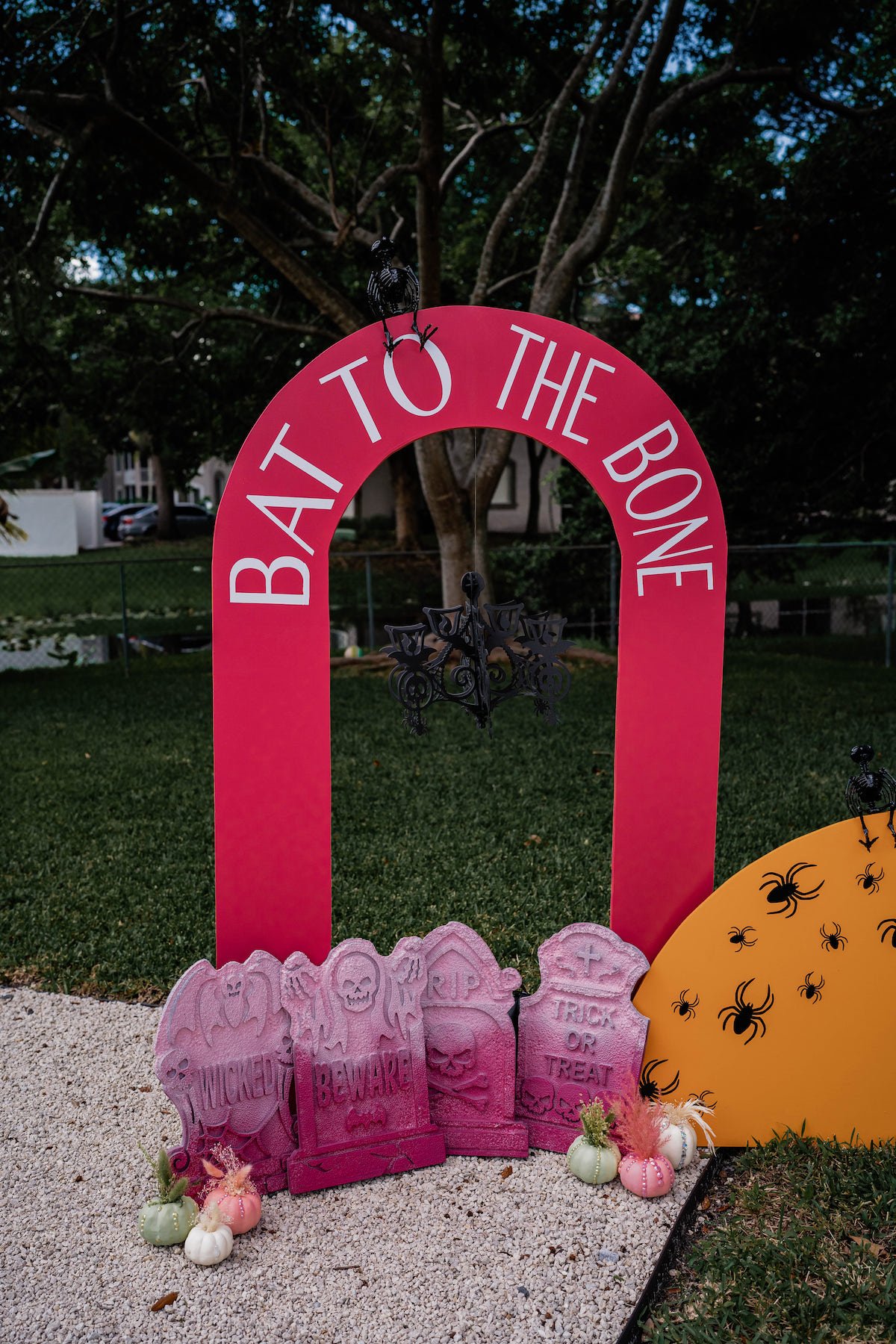 Bat to the bone party arch with pink tombstones