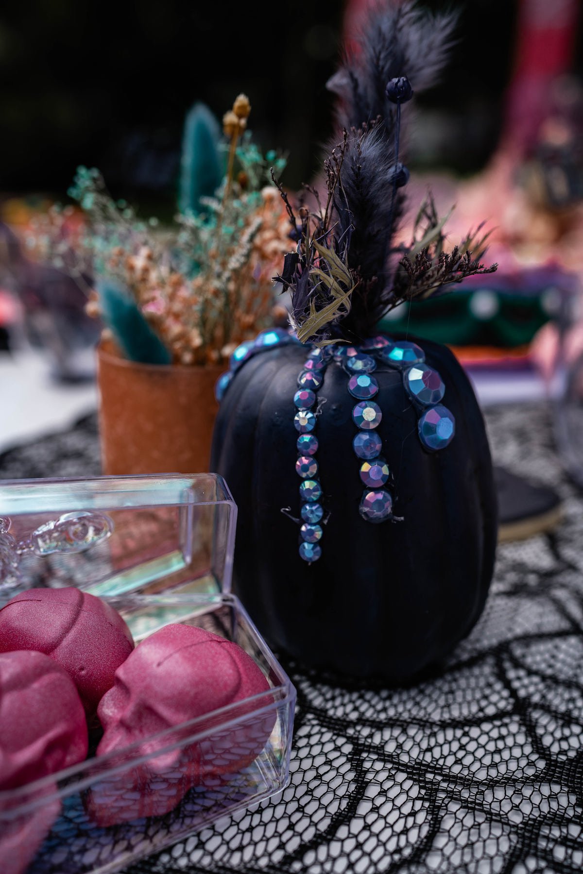 Black jeweled pumpkin party decoration and pink skull heads
