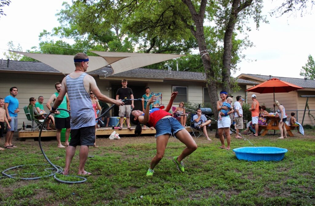 Water hose limbo game - see a complete list of fun and affordable water games for kids!