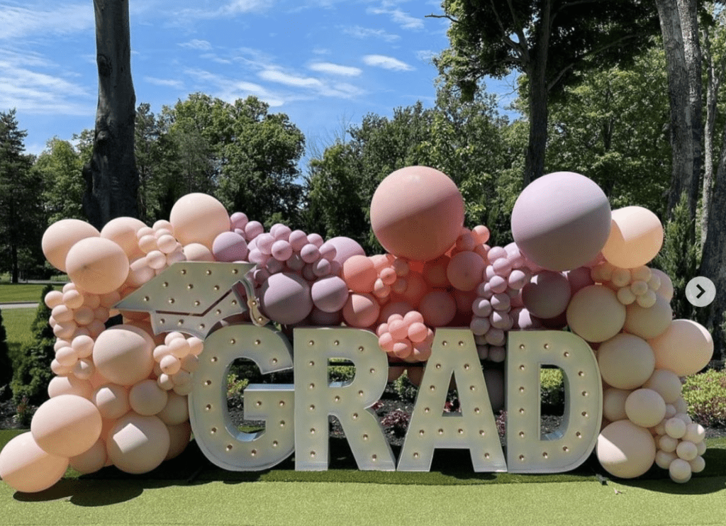 Grad marquee sign with balloons