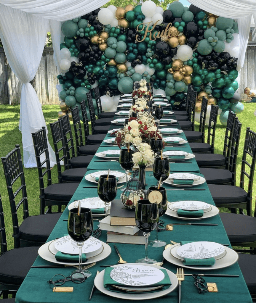 Green, black, gold, and white graduation party table decor and backdrop