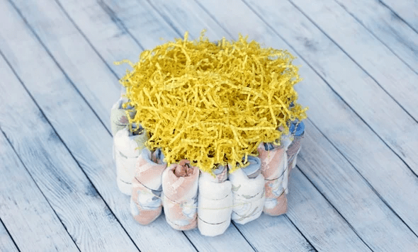 Crinkle paper added to the top of a mini diaper cake