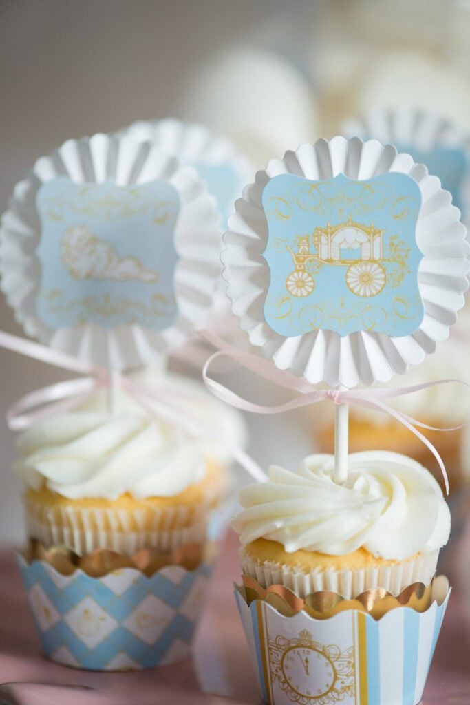 Cinderella-themed carriage cupcake toppers in vanilla cupcakes