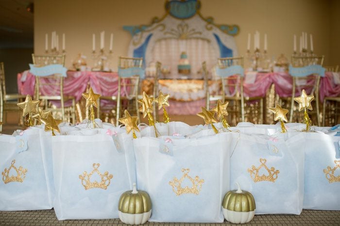 Cinderella party favor bags with gold glitter crowns and gold star magic wands