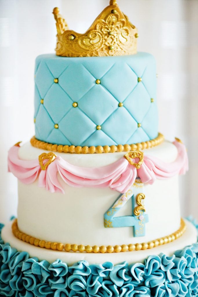 Stunning three-tiered blue, pink, gold, and white Cinderella-inspired birthday cake for a 4 year old